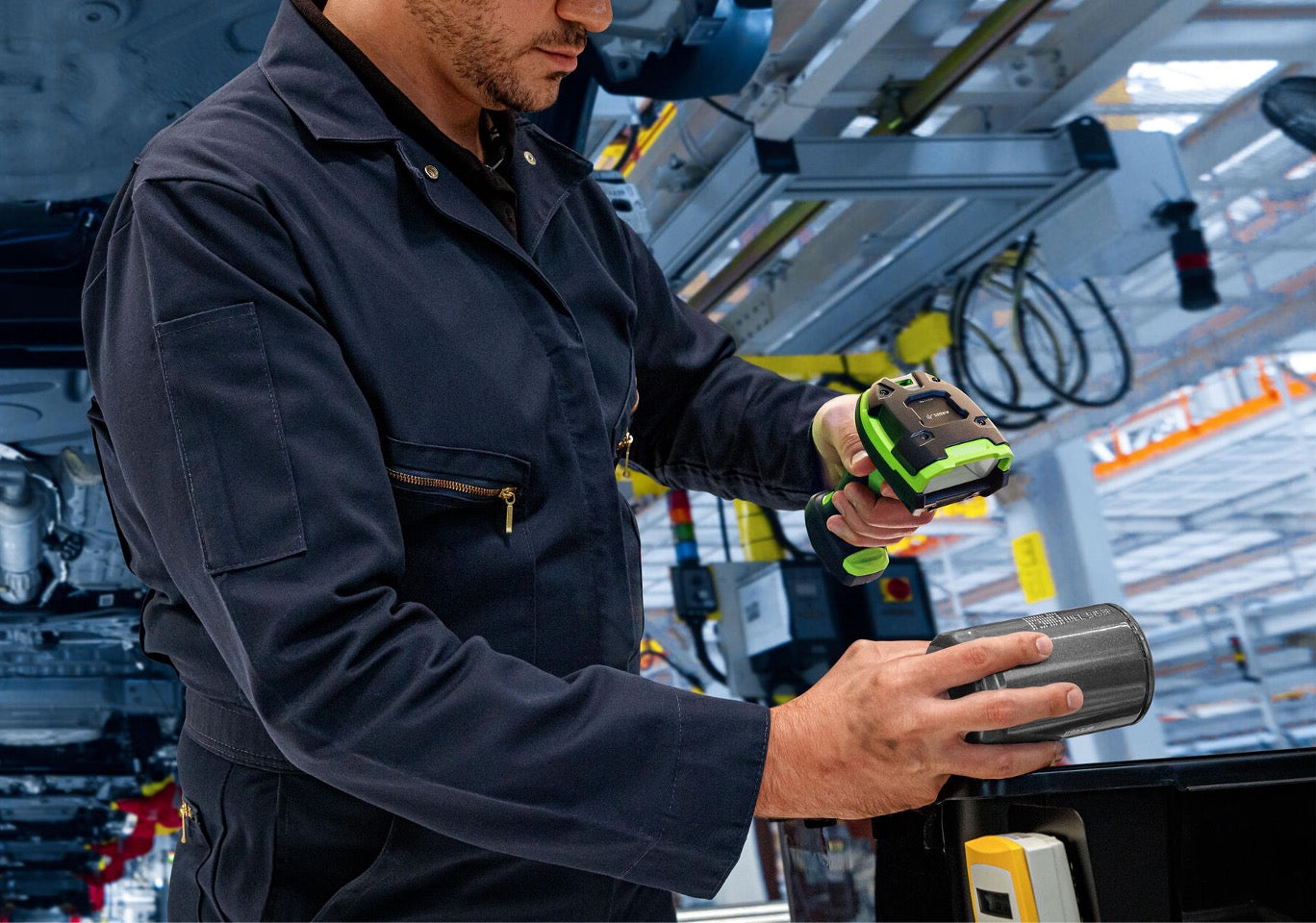 man holding barcode scanner reading barcode in smart factory